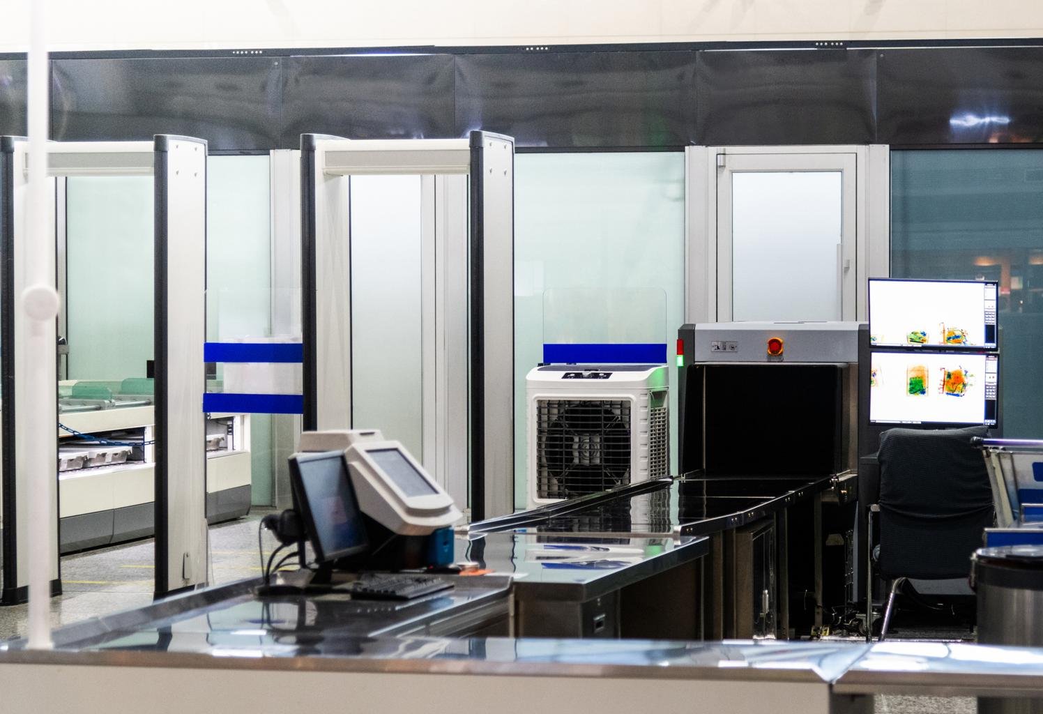 Lost laptop at airport security checkpoint tray near baggage scanner