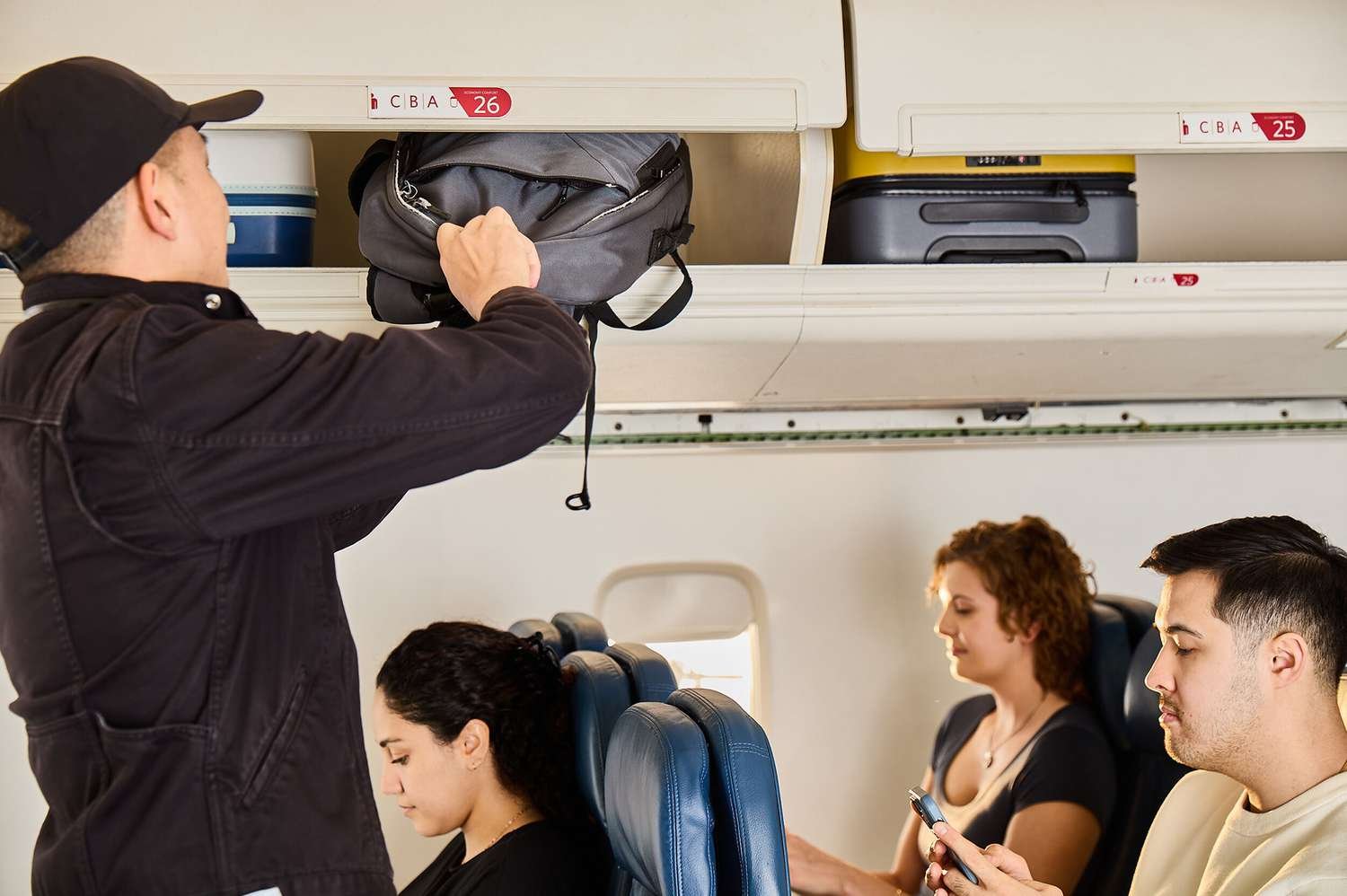 Traveler weighing luggage at airport check-in counter to avoid excess baggage charges